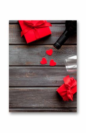 Valentines Day concept with wine, glasses, red present box on dark wooden background top-down copy space