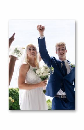 Bride and groom celebrating outdoors, holding hands and smiling joyfully