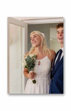 Bride and groom joyfully entering wedding venue, smiling and holding bouquet