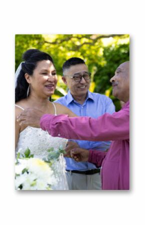 Greeting guests, bride in white dress smiling at outdoor senior wedding ceremony