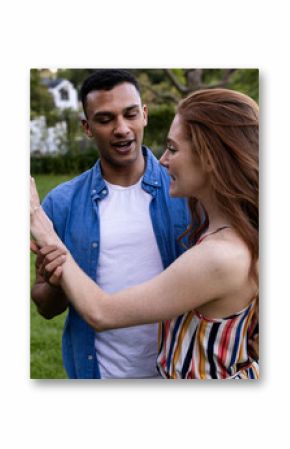 Young couple enjoying playful moment together in lush green park