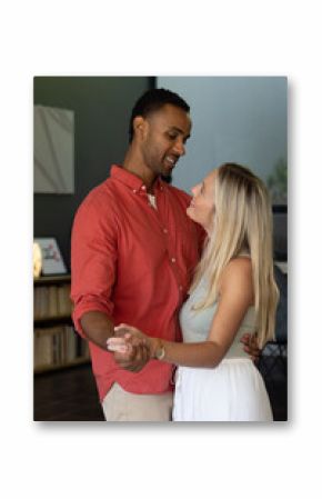 Couple dancing closely at home, sharing joyful moments and smiling warmly