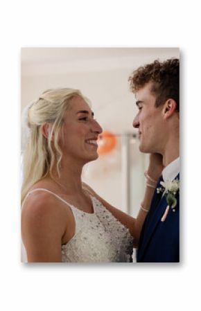 Bride and groom sharing joyful moment, smiling and embracing at wedding celebration