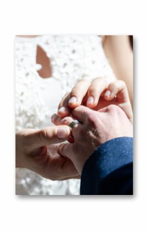 Bride placing ring on groom's finger during wedding ceremony, hands close-up