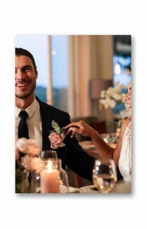 Bride and groom laughing together at elegant wedding reception dinner
