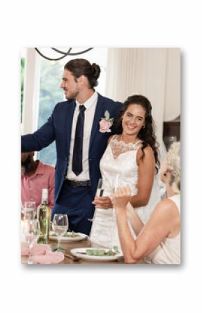 Bride and groom toasting with guests at elegant wedding reception indoors