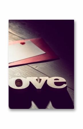 Love text with envelope on wooden table