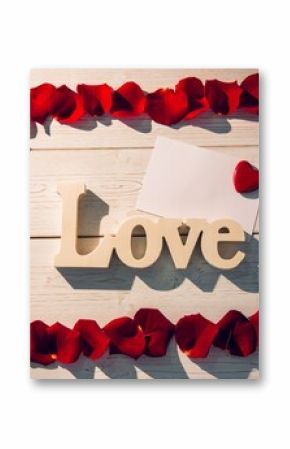 Frame of red rose petals with love text