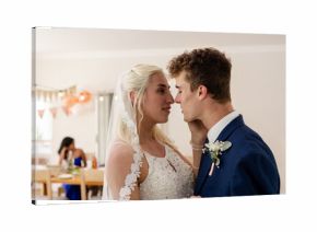 Bride and groom looking into each other's eyes during wedding celebration