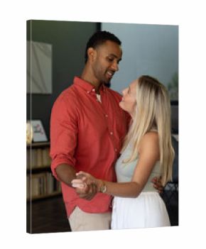 Couple dancing closely at home, sharing joyful moments and smiling warmly