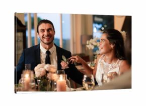 Bride and groom laughing together at elegant wedding reception dinner