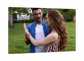 Young couple enjoying playful moment together in lush green park