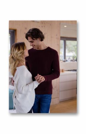 Christmas time, Couple dancing by fireplace, sharing romantic moment in cozy home setting