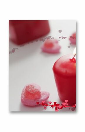 Image of multiple red hearts over red candles