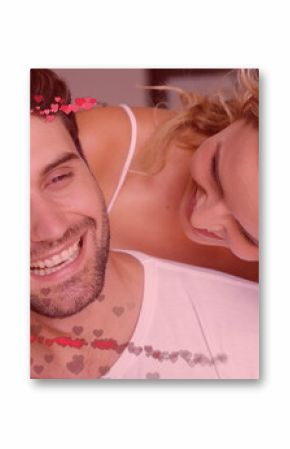 Image of red hearts over couple in love embracing and smiling
