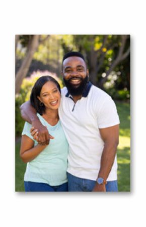 Smiling couple standing outdoors, embracing and enjoying quality time together