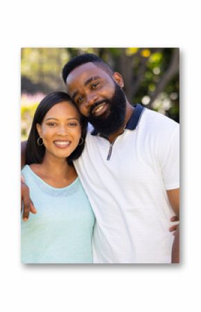 Smiling couple embracing outdoors, enjoying quality time together in garden