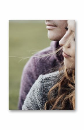 Young loving couple sitting on the grass