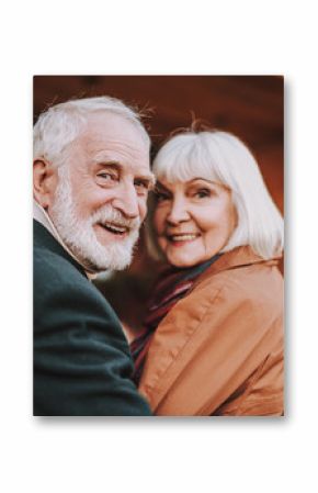 Portrait of joyful bearded man and his wife turning back and smiling. Focus on man