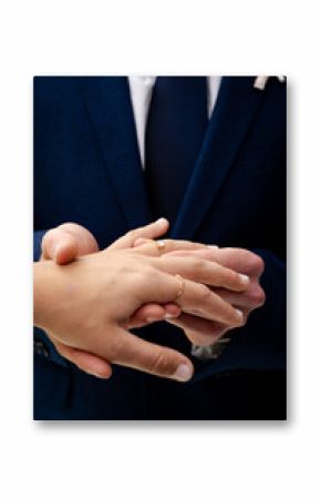 Couple exchanging rings during wedding ceremony, holding hands and showing love