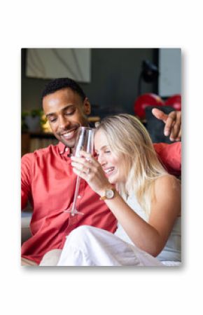 Couple celebrating at home, enjoying champagne and sharing joyful moments together