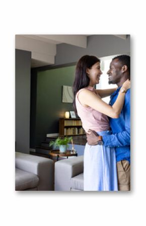 Couple embracing and smiling at home, enjoying joyful moment together