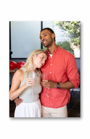 Couple celebrating at home, holding champagne glasses and enjoying moment