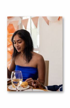 Smiling couple sharing joyful moments and meal at wedding celebration together