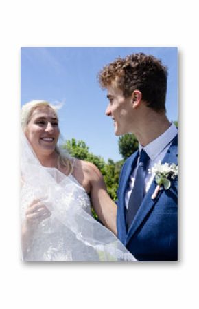 Bride and groom smiling joyfully outdoors in lush garden setting