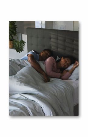 Sleeping peacefully together, African American couple in cozy bedroom setting