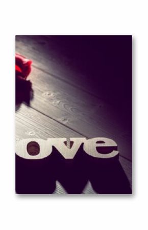Love text with rose on wooden table