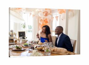 Smiling couple enjoying wedding celebration at beautifully decorated dining table