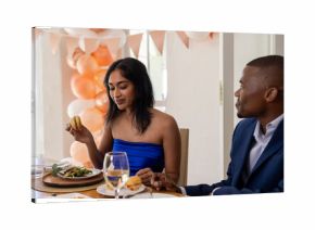 Smiling couple sharing joyful moments and meal at wedding celebration together