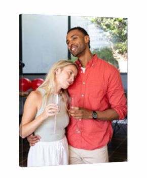 Couple celebrating at home, holding champagne glasses and enjoying moment