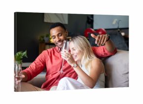 Couple celebrating at home, enjoying champagne and sharing joyful moments together