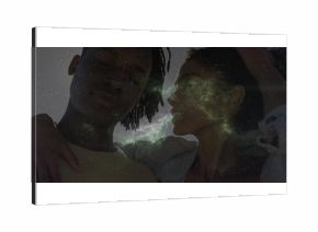 Leaning adults wearing mustard t-shirt and light denim jacket under starry greenish nebula sky