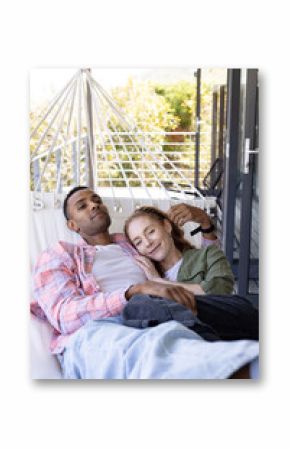 Relaxing on hammock, multiracial couple enjoying peaceful afternoon at home