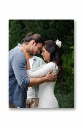 Couple embracing lovingly in garden, celebrating romantic small casual wedding day together
