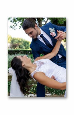 Bride and groom dancing joyfully outdoors, sharing romantic moment together