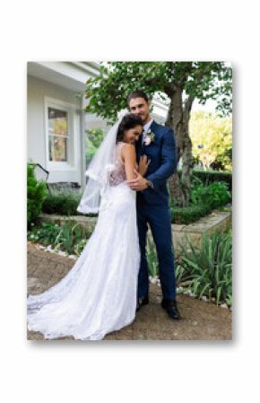 Bride and groom embracing outdoors, celebrating love on wedding day