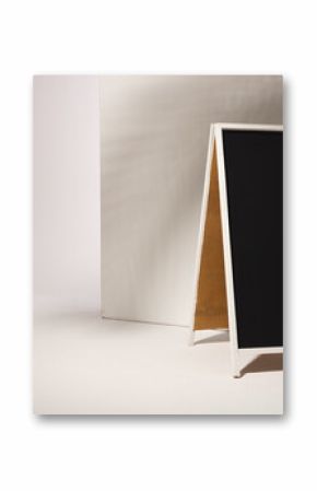 A blank sandwich board sign stands ready for advertising messages, with copy space