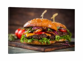Tasty burgers on wooden table.