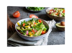 Healthy arugula salad with avocado, radish, bell pepper, tomato and Roquefort cheese