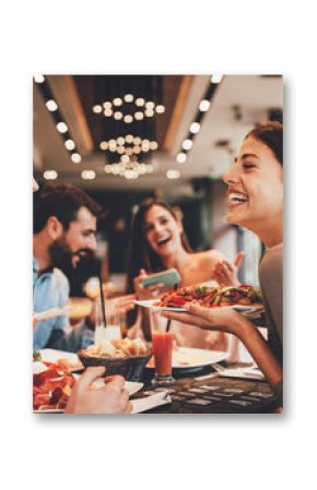 Group of Happy friends having breakfast in the restaurant