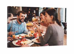 Group of Happy friends having breakfast in the restaurant