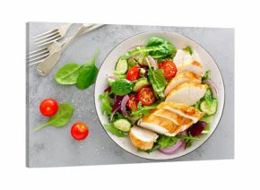 Grilled chicken breast, fillet and fresh vegetable salad of lettuce, arugula, spinach, cucumber and tomato. Healthy lunch menu. Diet food. Top view