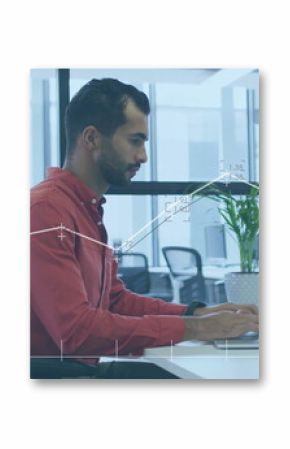 Typing Middle Eastern male employee entering report on laptop in open-plan office, with plant