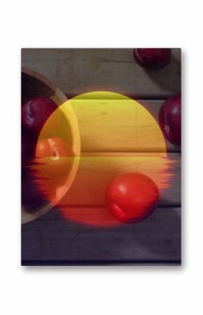 Displaying wooden bowl holding red plums on worn plank table showing glitch sun overlay, copy space
