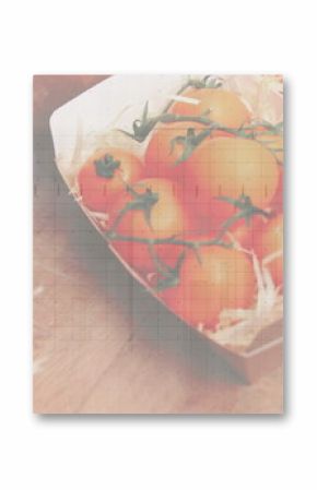 Showing cardboard box holding vine tomatoes on rustic wooden table, with straw packing, copy space