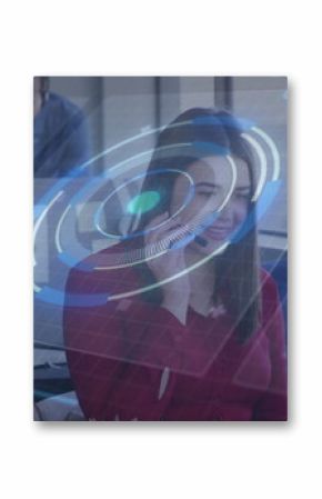 Agent wearing red blouse headset manipulating holographic overlay in open office with monitor